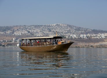 Tiberias  is a city on the western shore of the Sea of Galilee in the Lower Galilee. Established in 20 CE, it was named in honour of the emperor Tiberius.Tiberias has been venerated in Judaism since the middle of the 2nd century CE and since the 16th century has been considered one of Judaism's Four Holy Cities, along with Jerusalem, Hebron and Safed.In the 2nd-10th centuries, Tiberias was the largest Jewish city in the Galilee and the political and religious hub of the Jews of Palestine. According to Christian tradition, Jesus performed several miracles in the Tiberias district, making it an important pilgrimage site for Christians. Tiberias has historically been known for its hot springs, believed to cure skin and other ailments, for thousands of years.The picture shows a Pilgrim' s boat on the lake. Photo by Itamar Grinberg.